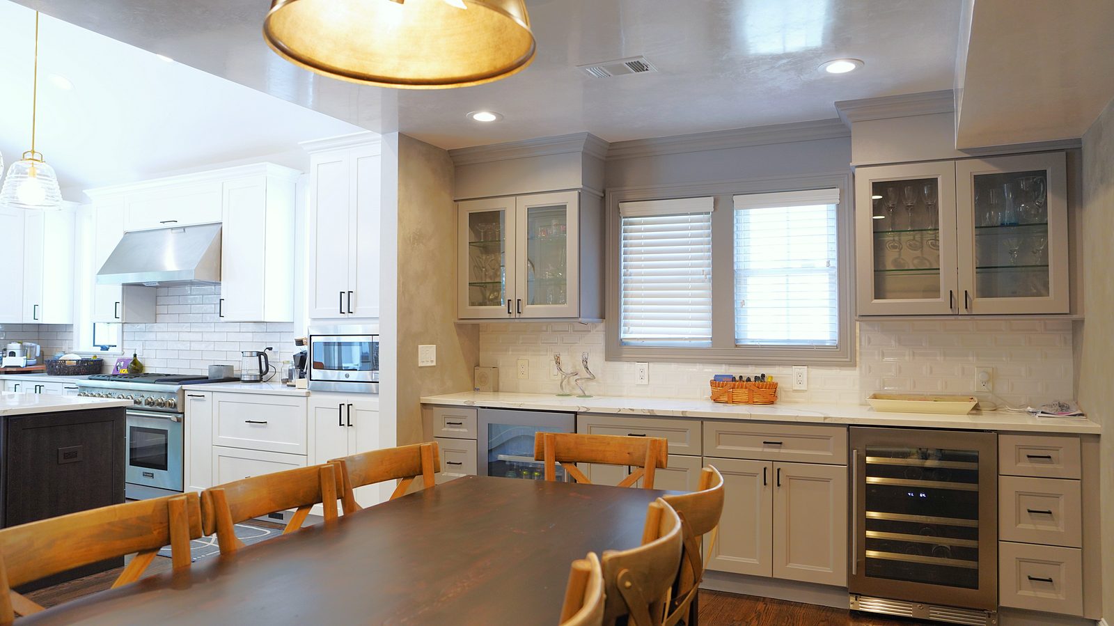 Kitchen and dining area with the long table, honeycomb pendant and wine fridge