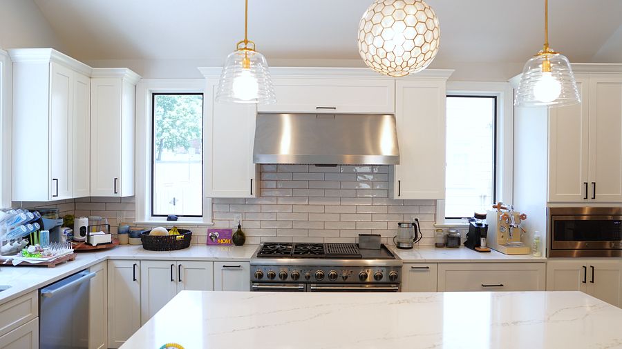 Project 38: White shaker kitchen with a black island under a vaulted ceiling