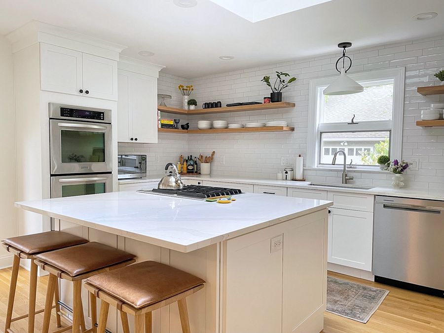 White shaker kitchen with floating shelves and subway tile to the ceiling