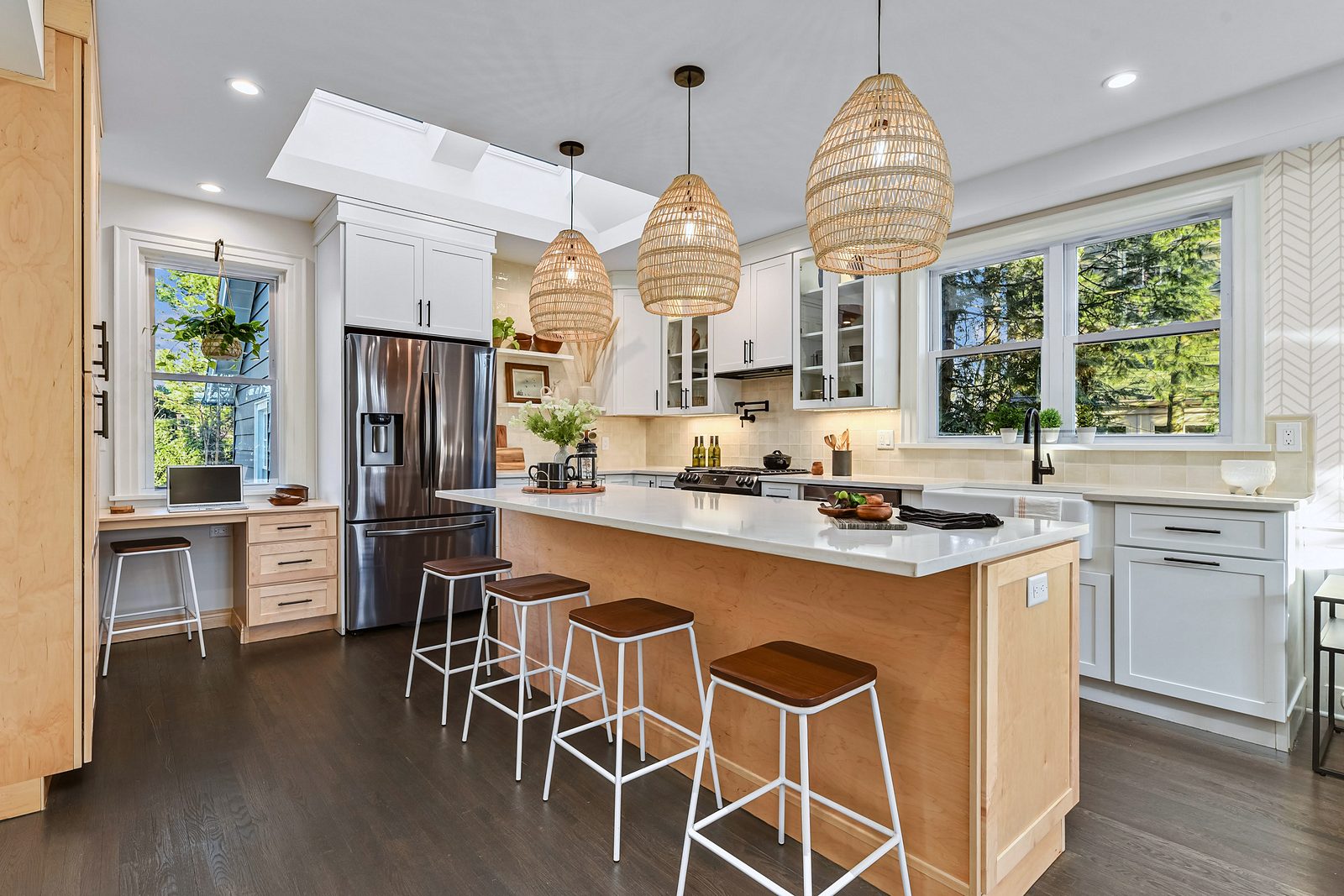 White shaker perimeter with glass-front uppers — White shaker kitchen with a natural wood island and rattan pendants