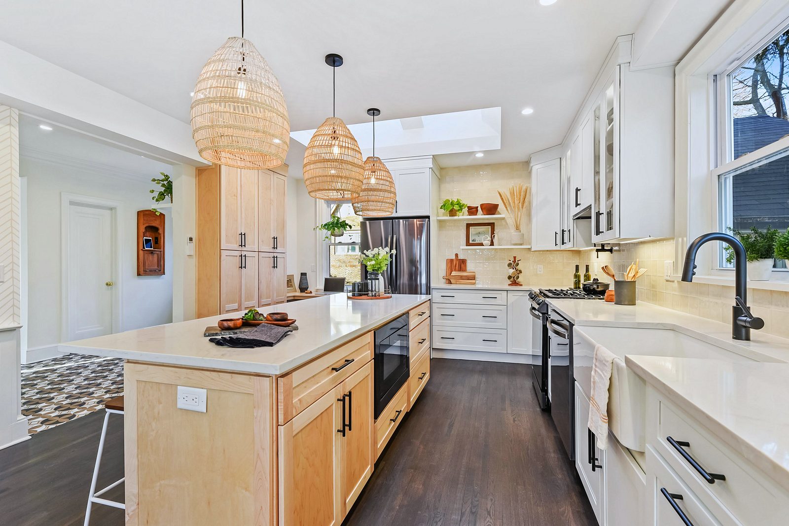 Rattan pendants — White shaker kitchen with a natural wood island and rattan pendants