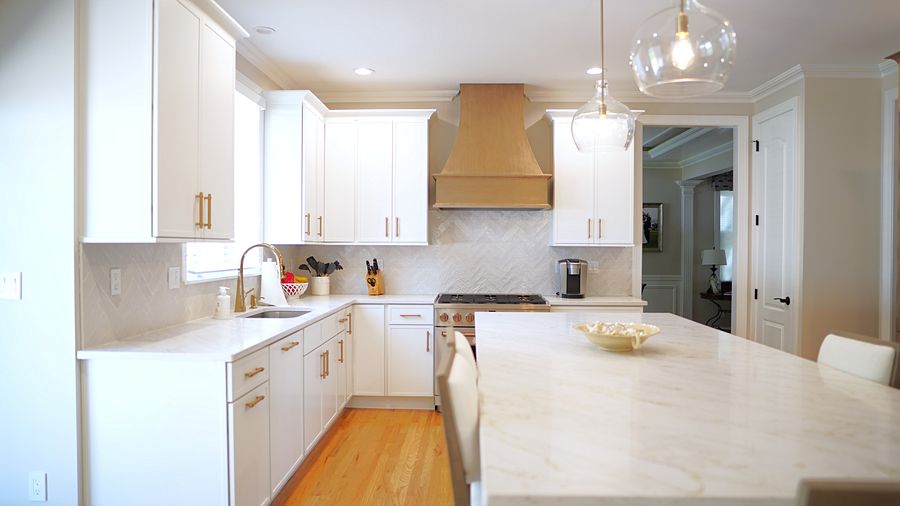 Project 35: White shaker kitchen with a wood hood and an oak pantry wall