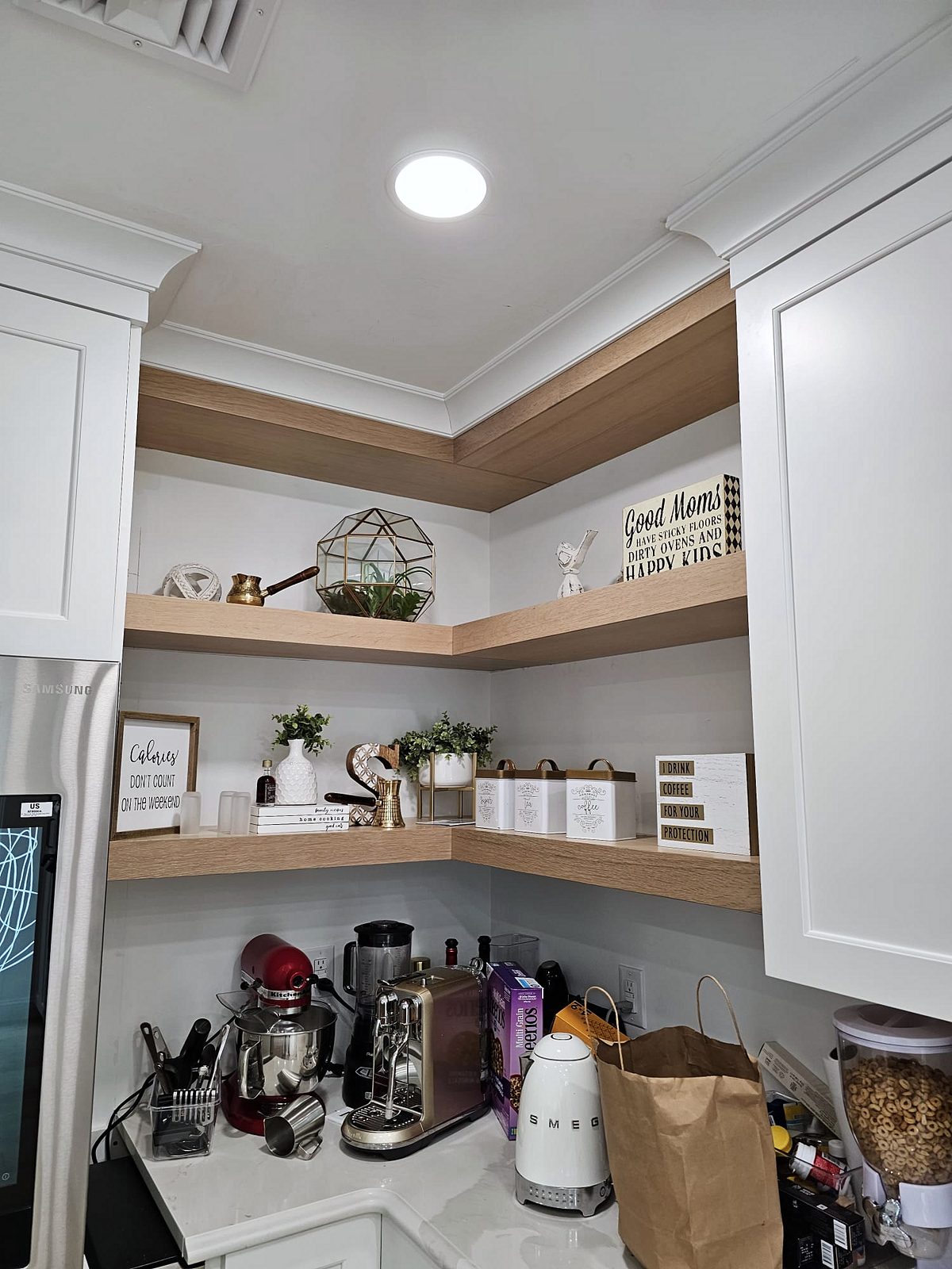 Stained wood island on turned legs — White shaker kitchen with X-mullion glass uppers and a stained wood island on turned legs