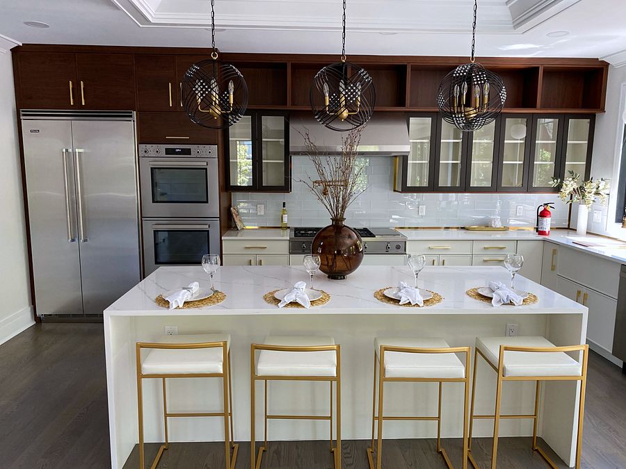White slab and walnut kitchen with a waterfall island