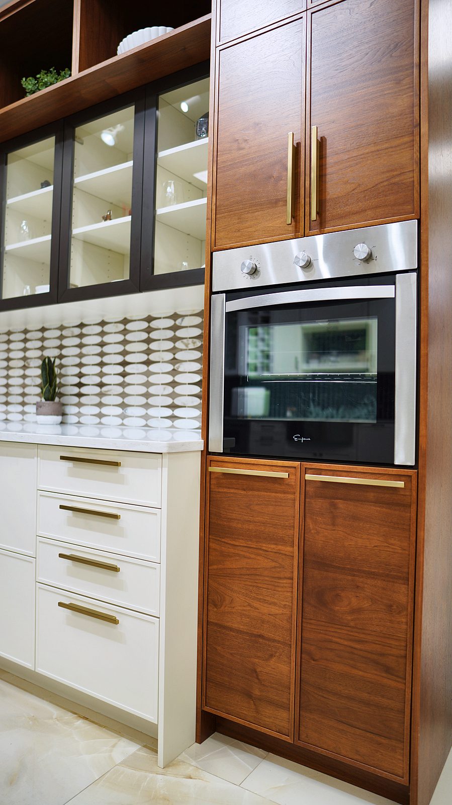 Kitchen display at My House Kitchen — Walnut tall cabinets with glass uppers